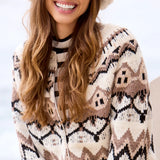 Woman wearing a patterned cardigan and hat with a blurred background