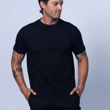 Man wearing a black t-shirt and shorts against a light gray background