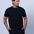 Man wearing a black t-shirt and shorts against a light gray background