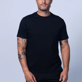 Man wearing a black t-shirt and shorts on a light gray background