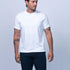 Man wearing a white t-shirt and navy shorts on a light gray background