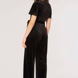 Carve an elegant silhouette in this sleek velvet jumpsuit, designed for party season. Framed by a V-neckline and angel sleeves, it boasts a flattering wrap bodice, a wide-leg cut, and side seam pockets. It's finished with a fabric belt to create a cinched-in silhouette. Style with heels and a clutch to complete the look.