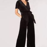 Carve an elegant silhouette in this sleek velvet jumpsuit, designed for party season. Framed by a V-neckline and angel sleeves, it boasts a flattering wrap bodice, a wide-leg cut, and side seam pockets. It's finished with a fabric belt to create a cinched-in silhouette. Style with heels and a clutch to complete the look.