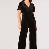 Carve an elegant silhouette in this sleek velvet jumpsuit, designed for party season. Framed by a V-neckline and angel sleeves, it boasts a flattering wrap bodice, a wide-leg cut, and side seam pockets. It's finished with a fabric belt to create a cinched-in silhouette. Style with heels and a clutch to complete the look.