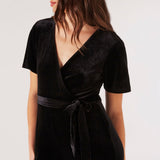 Carve an elegant silhouette in this sleek velvet jumpsuit, designed for party season. Framed by a V-neckline and angel sleeves, it boasts a flattering wrap bodice, a wide-leg cut, and side seam pockets. It's finished with a fabric belt to create a cinched-in silhouette. Style with heels and a clutch to complete the look.