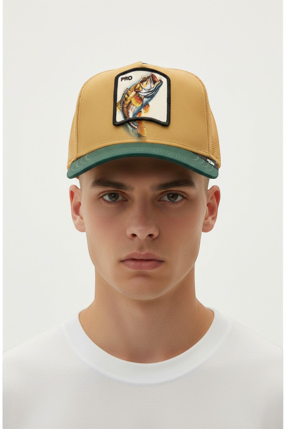 Broderick's Clothing Co. Goorin Bros. tan and green trucker hat with a fish patch worn by a male model