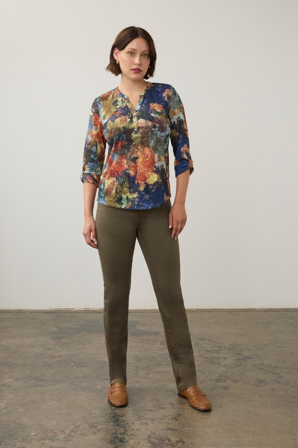 Broderick's Clothing Co. FDJ 3/4 sleeve henley top with a multi-coloured abstract print, worn with olive green pants.