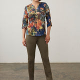 Broderick's Clothing Co. FDJ 3/4 sleeve henley top with a multi-coloured abstract print, worn with olive green pants.