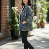 Model wearing a Broderick's Clothing Co. Shannon Passero Karol Cardigan with patterned fabric and denim trim pockets.