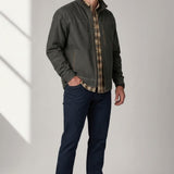 Broderick's Clothing Co. KÜHL BURR jacket in dark olive canvas worn by a man with a plaid shirt and dark jeans