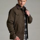 Broderick's Clothing Co. KÜHL MAVERICK brown canvas jacket with fleece lining worn by a man in a studio setting
