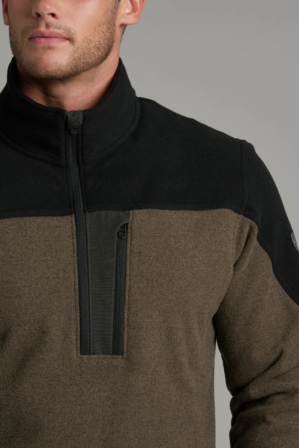 Broderick's Clothing Co. KÜHL SKORCHR fleece quarter-zip sweater in olive green and black with a chest zip pocket.