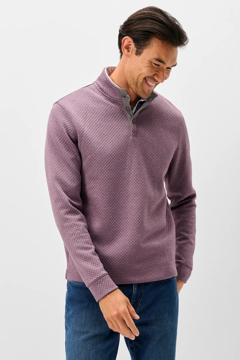 Broderick's Clothing Co. purple diamond quilted henley pullover with suede placket details worn by a smiling man