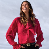 Broderick's Clothing Co. red sheer chiffon blouse with polka dot texture, bow-tie neck, and ruffled long sleeves.