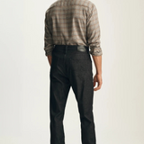 Broderick's Clothing Co. 34 Heritage Courage black straight leg jeans worn by a man in a plaid shirt, back view.