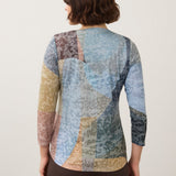 Back view of Broderick's Clothing Co. FDJ 3/4 sleeve notch neck top with a multi-colored abstract geometric pattern.