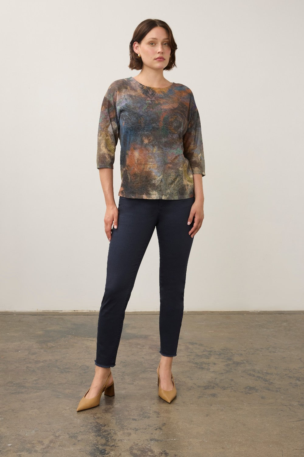 Model wearing a Broderick's Clothing Co. FDJ 3/4 sleeve top with a multi-coloured abstract print and relaxed fit.
