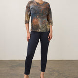 Model wearing a Broderick's Clothing Co. FDJ 3/4 sleeve top with a multi-coloured abstract print and relaxed fit.