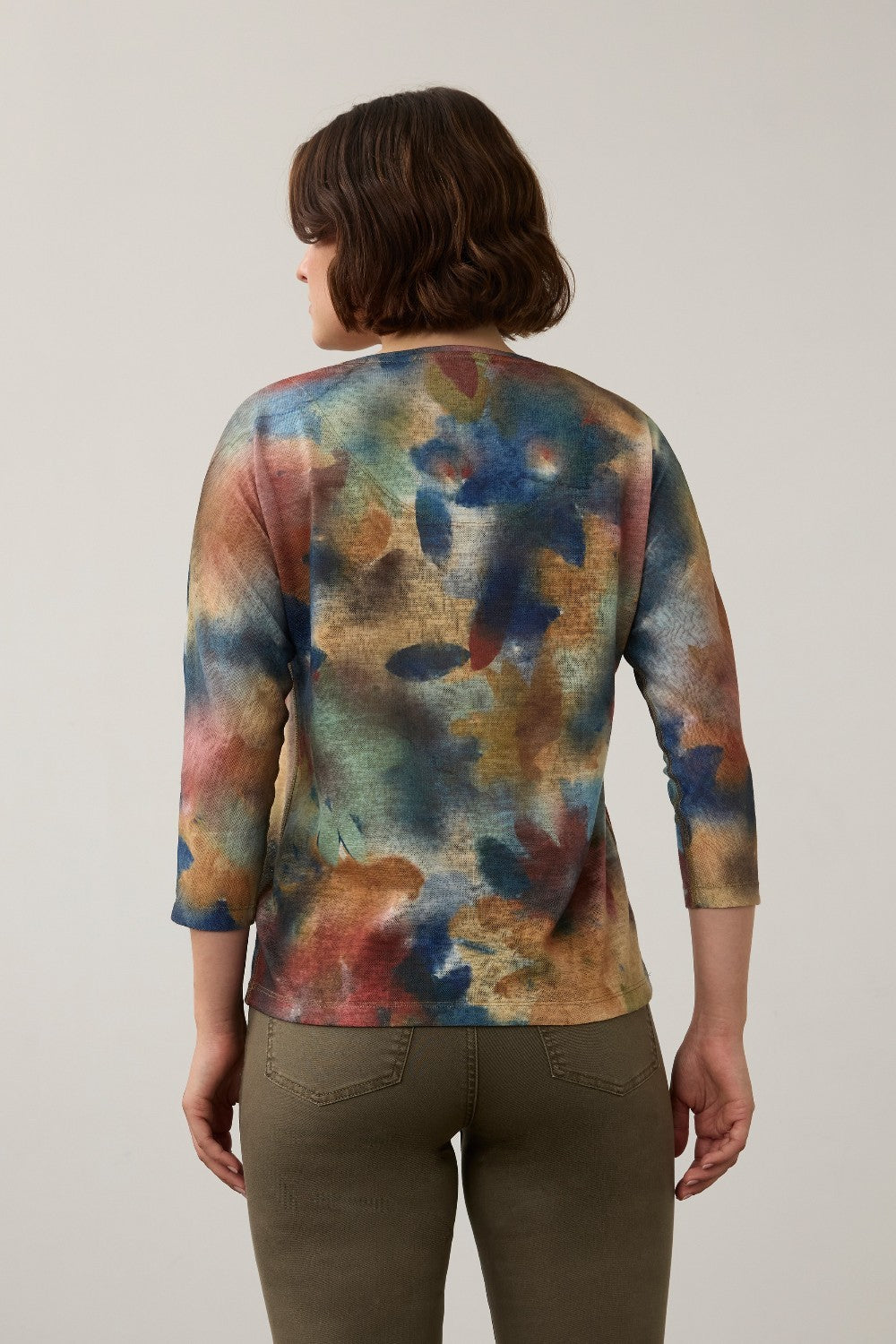 Back view of a Broderick's Clothing Co. FDJ drop shoulder 3/4 sleeve top with a multi-colored abstract fall print.