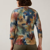Back view of a Broderick's Clothing Co. FDJ drop shoulder 3/4 sleeve top with a multi-colored abstract fall print.