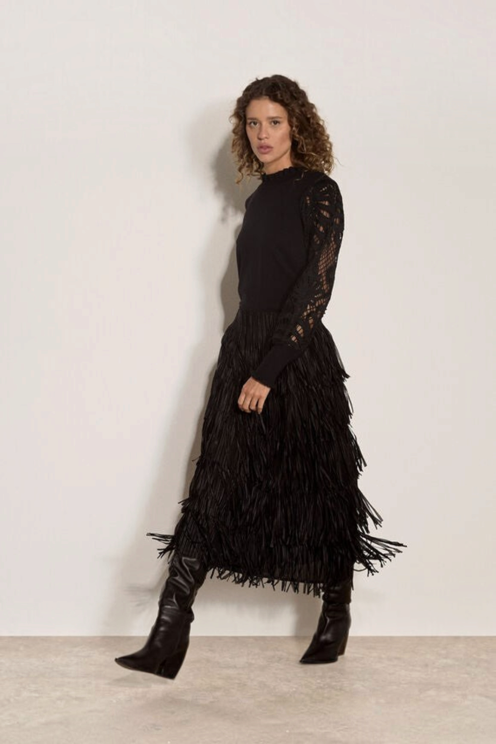 Broderick's Clothing Co. apricot jumper with black guipure lace sleeves and lettuce trim worn with a fringe skirt.