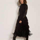 Broderick's Clothing Co. apricot jumper with black guipure lace sleeves and lettuce trim worn with a fringe skirt.