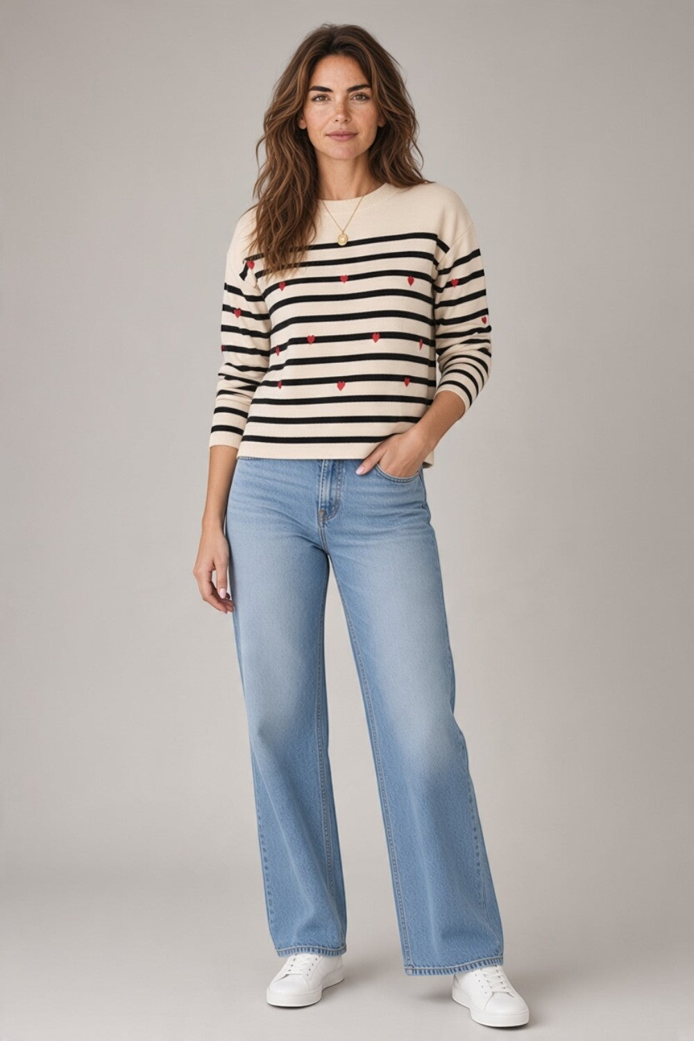 Broderick's Clothing Co. apricot crew neck sweater with black stripes and small red embroidered hearts.