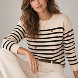Broderick's Clothing Co. apricot crew neck sweater with black horizontal stripes and small red embroidered hearts.