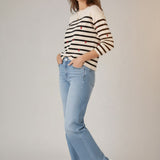 Broderick's Clothing Co. apricot striped crew neck sweater with red embroidered hearts worn with light wash jeans.