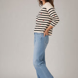 Broderick's Clothing Co. apricot striped sweater with red embroidered hearts, crew neck, and ribbed trim on a model.