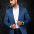 Broderick's Clothing Co. Au Noir EAMES medium blue blazer worn by a man with a white shirt against a damask background