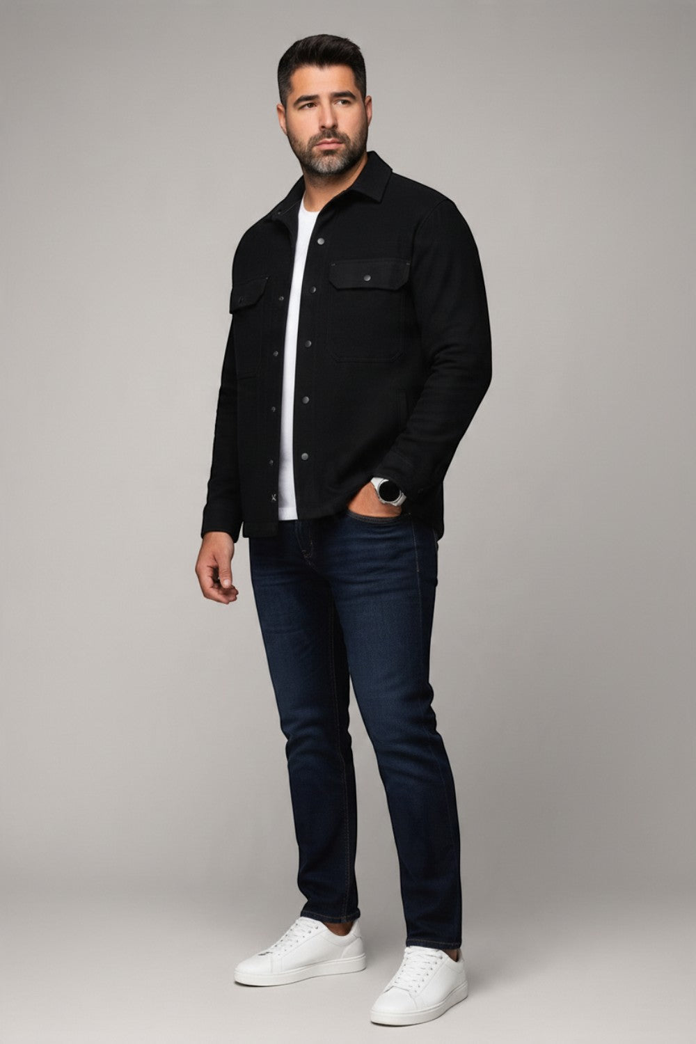 Model wearing a black Broderick's Clothing Co. Au Noir GRADO overshirt over a white t-shirt and dark blue jeans.