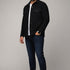 Model wearing a black Broderick's Clothing Co. Au Noir GRADO overshirt over a white t-shirt and dark blue jeans.
