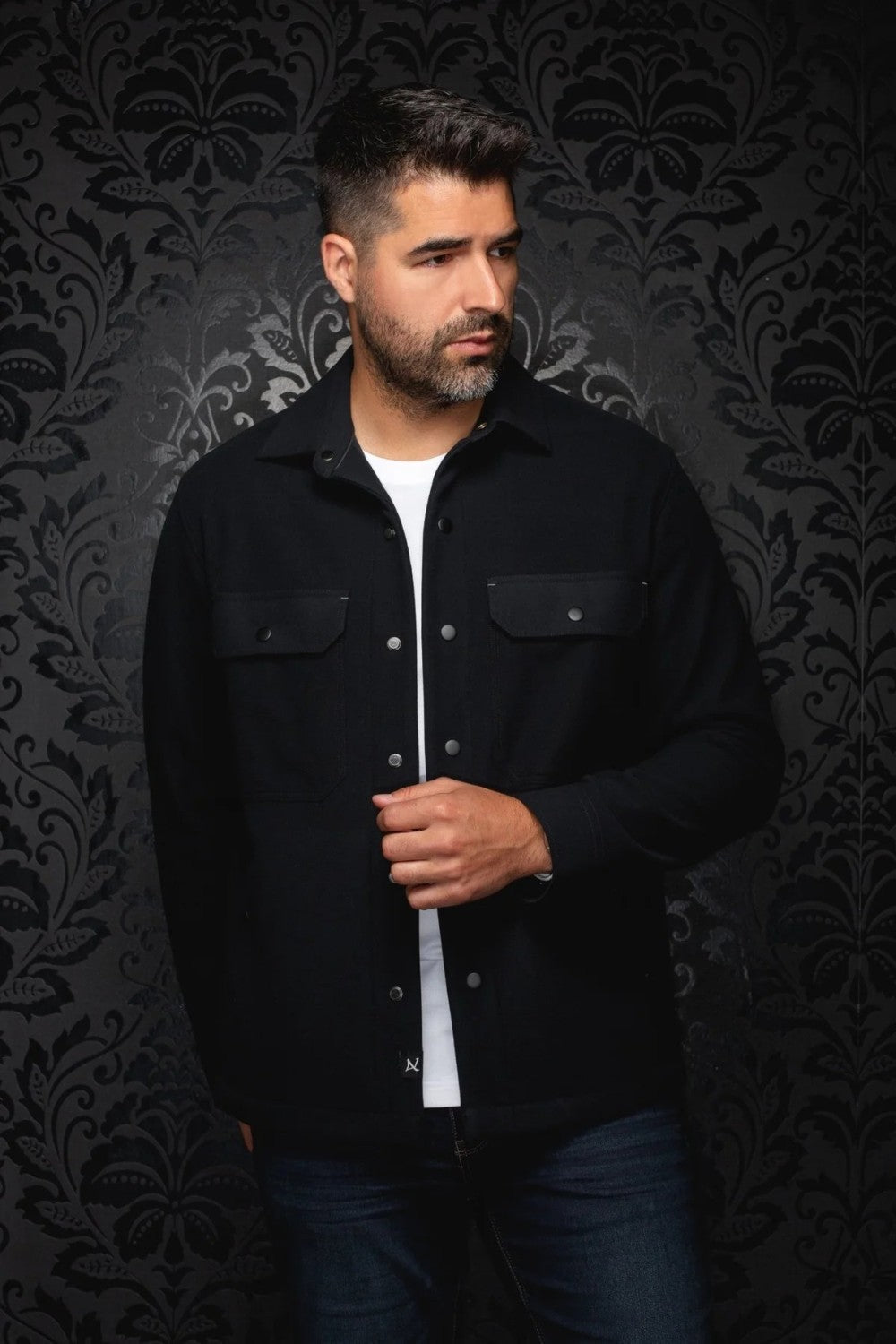 Broderick's Clothing Co. Au Noir GRADO black overshirt worn by a man over a white t-shirt with button-down pockets.