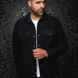 Broderick's Clothing Co. Au Noir GRADO black overshirt worn by a man over a white t-shirt with button-down pockets.