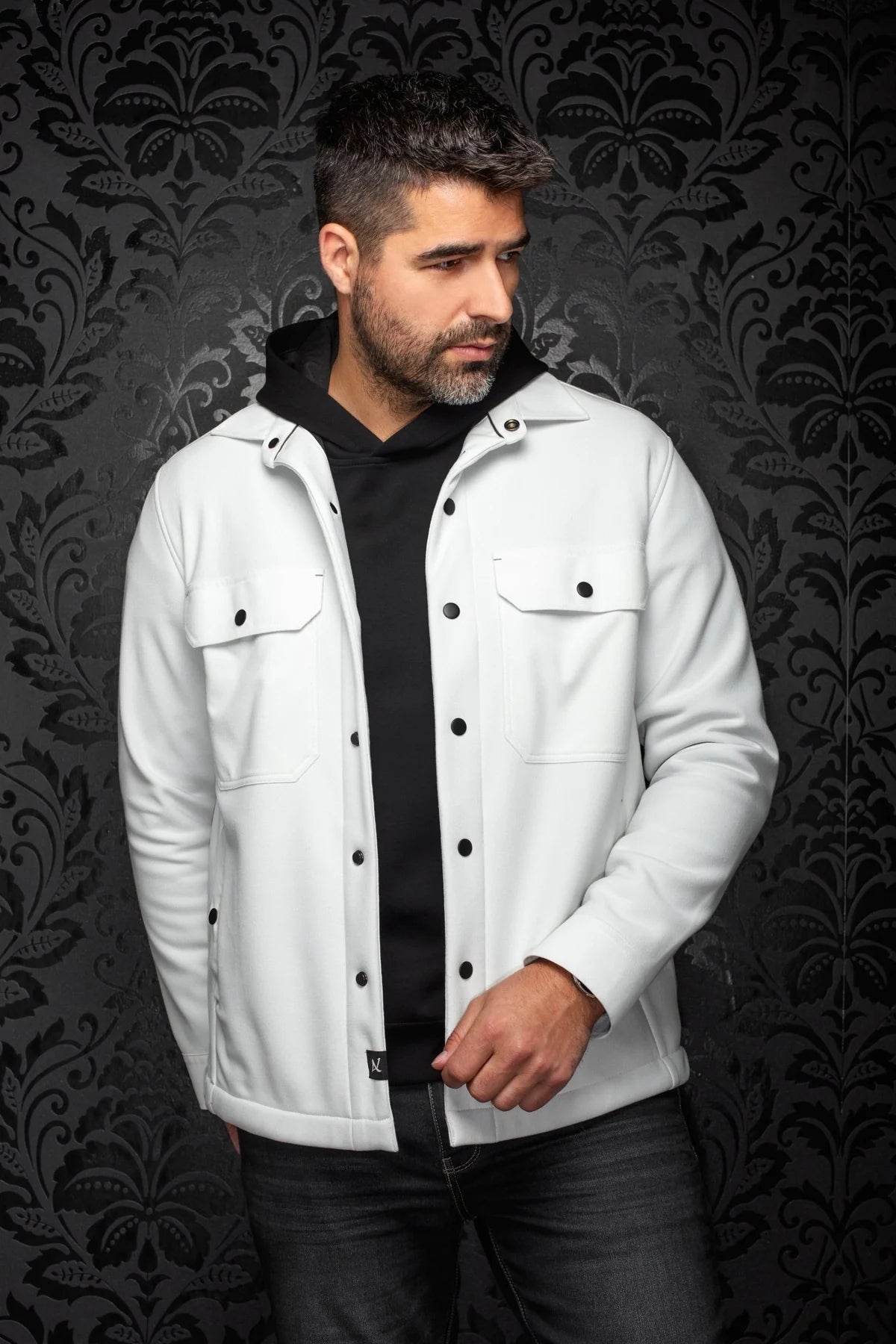 Broderick's Clothing Co. Au Noir GRADO white overshirt with black buttons worn over a black hoodie by a male model
