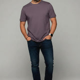 Man wearing a Broderick's Clothing Co. Au Noir C-MAVEN mauve modal and mercerized cotton t-shirt with dark blue jeans
