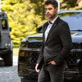 Broderick's Clothing Co. Au Noir SCARPA blazer in black worn by a man standing outdoors near a black SUV