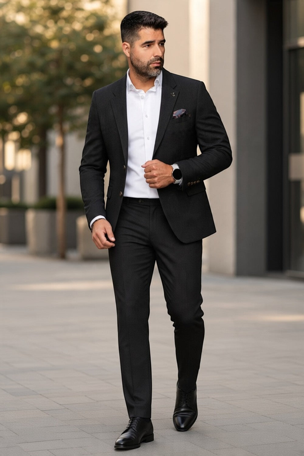 Man wearing a Broderick's Clothing Co. Au Noir TYCHO charcoal blazer with a white shirt and black trousers