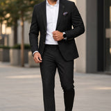 Man wearing a Broderick's Clothing Co. Au Noir TYCHO charcoal blazer with a white shirt and black trousers