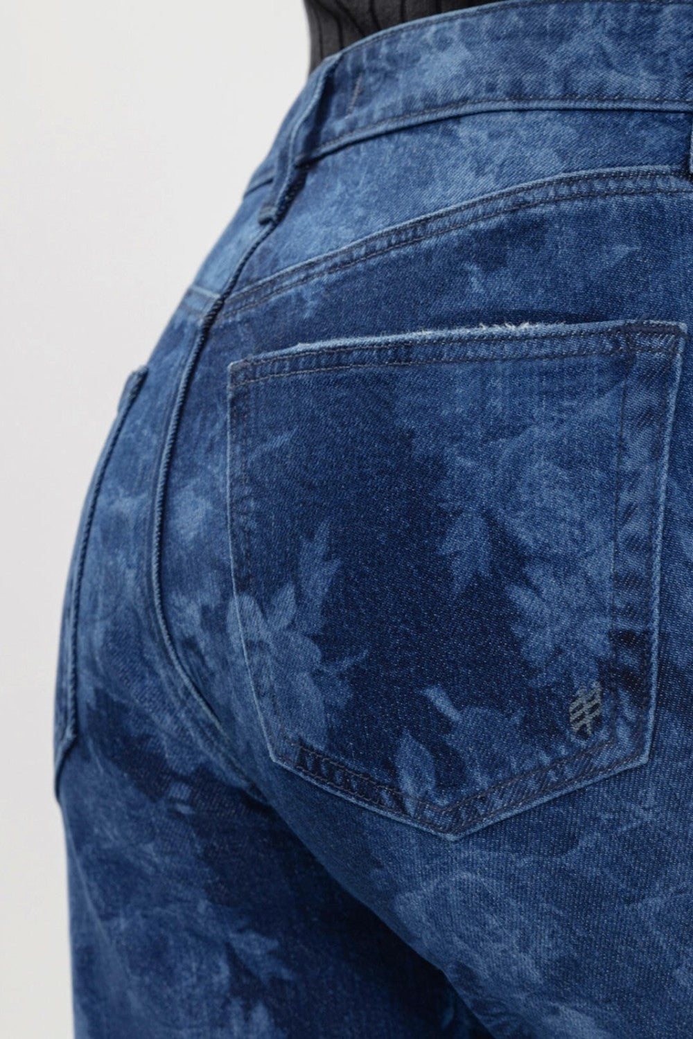 Broderick's Clothing Co. Avery high rise jeans in blue floral denim with a contoured waistband and back pocket detail.