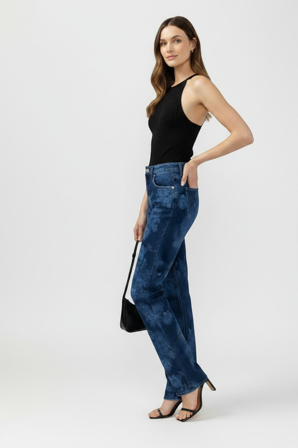 Broderick's Clothing Co. Avery high rise straight leg jeans in blue acid wash worn by a model with a black top