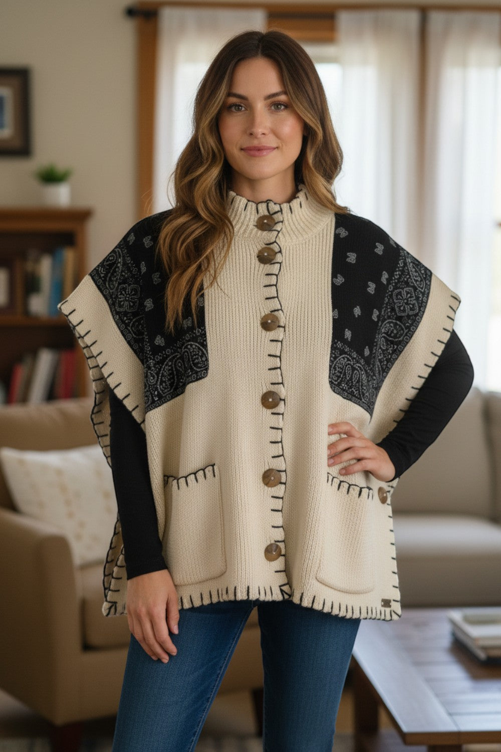 Broderick's Clothing Co. cream and black bandana print knit poncho with button front and whip-stitch edge detail.