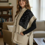 Broderick's Clothing Co. cream and black bandana print poncho with high neck, button front, and whip-stitch edges.