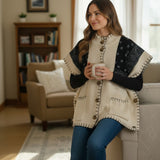 Broderick's Clothing Co. cream and black bandana print poncho with button front, high neck, and whip-stitch detail.