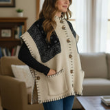 Broderick's Clothing Co. cream and black bandana print poncho with button front, pockets, and whip-stitch detailing.