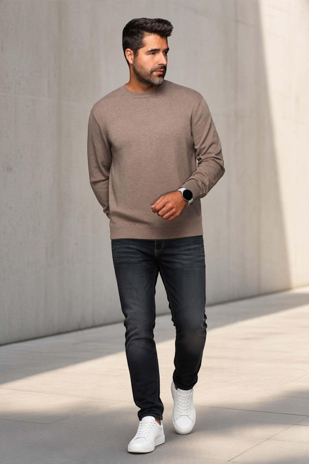 Man wearing a Broderick's Clothing Co. Au Noir LACAUNE beige cashmere crew neck sweater with dark jeans and sneakers.