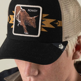 Broderick's Clothing Co. Goorin Bros. black trucker hat with a bull patch and tan mesh back worn by a man.