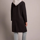 Broderick's Clothing Co. black knit car coat with grey removable fooler hoodie worn by a woman from the back view