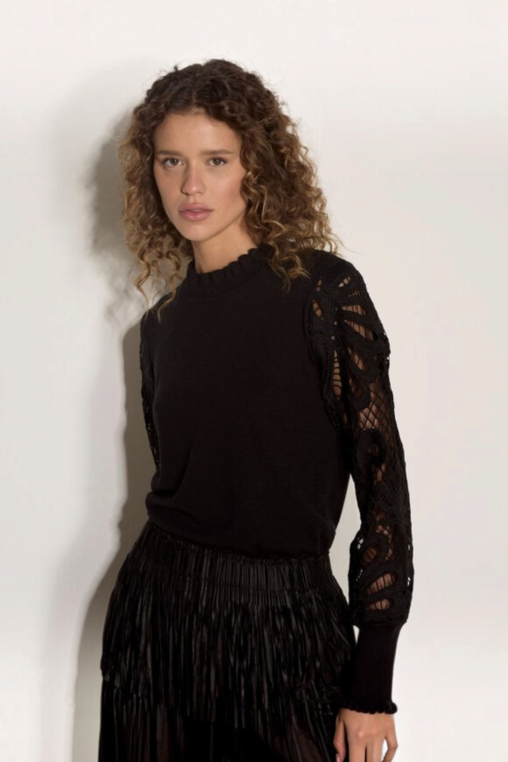 Broderick's Clothing Co. black jumper with crew neck, lettuce trim, and intricate guipure lace mesh sleeves.